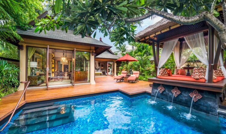 A private luxury villa with pool surrounded by tropical gardens in Bali, Southeast Asia.