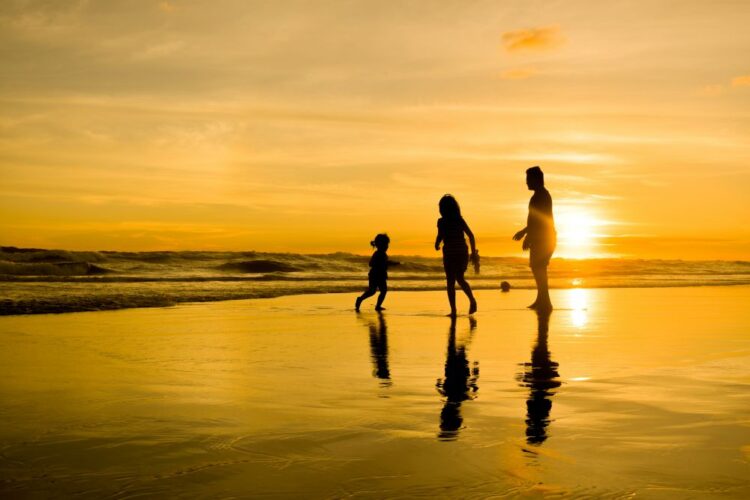 Luxury family travel experience at sunset beach designed by a luxury travel adviso