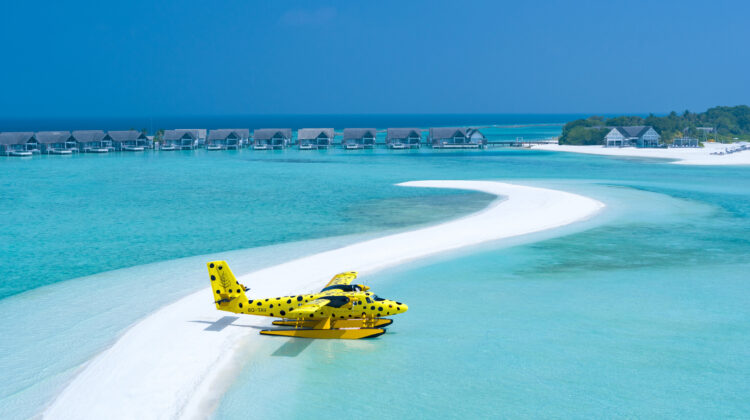 Luxury Maldives resort arrival by private seaplane with overwater villas