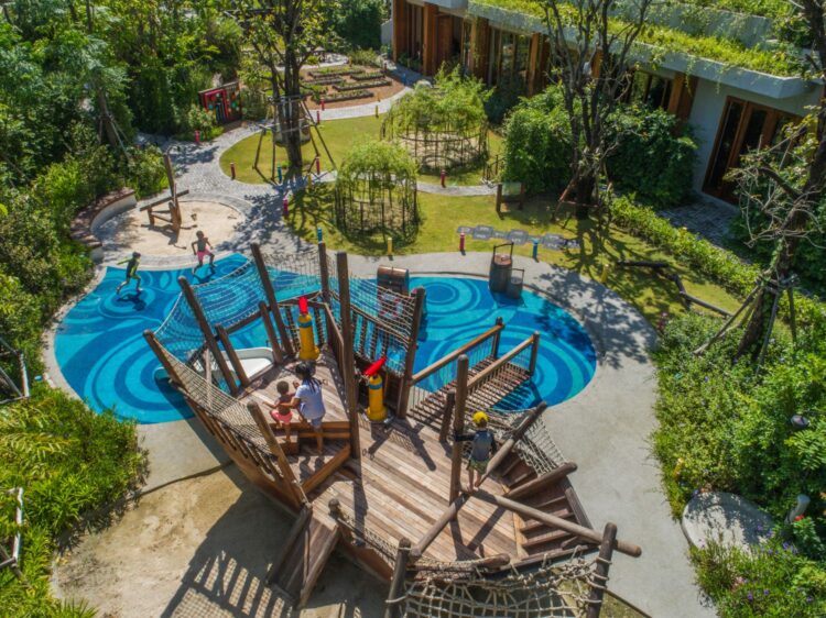 Luxury family resort in Thailand with outdoor kids’ playground and lush garden