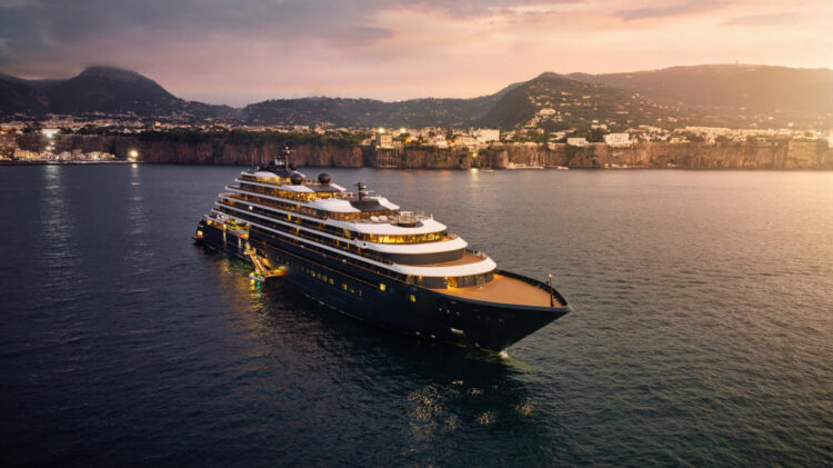 Evrima Ritz-Carlton Yacht docked in the Mediterranean at sunset