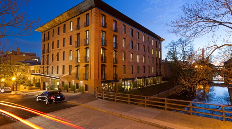 Elegant brick hotel building at dusk beside the canal in Georgetown