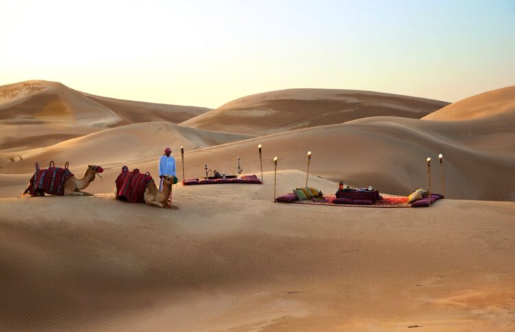 Luxury desert experience near Rosewood Abu Dhabi with private Bedouin-style setup and camels