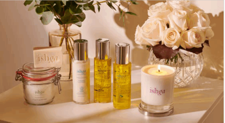 ishga spa products and candle displayed beside white roses, creating a calming luxury wellness ambiance.