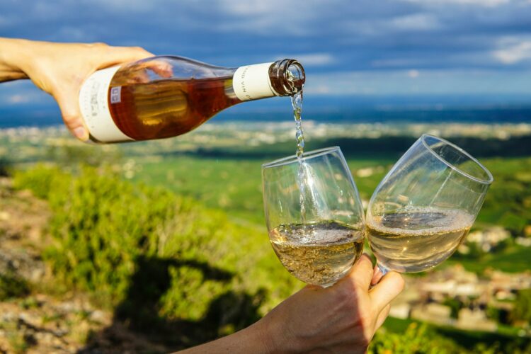 Pouring wine during a ladies weekend getaway in Napa Valley vineyard.