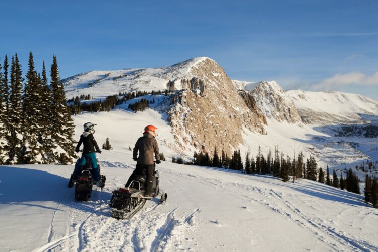 Winter snowmobiling adventure at Brush Creek Ranch Wyoming luxury family lodge