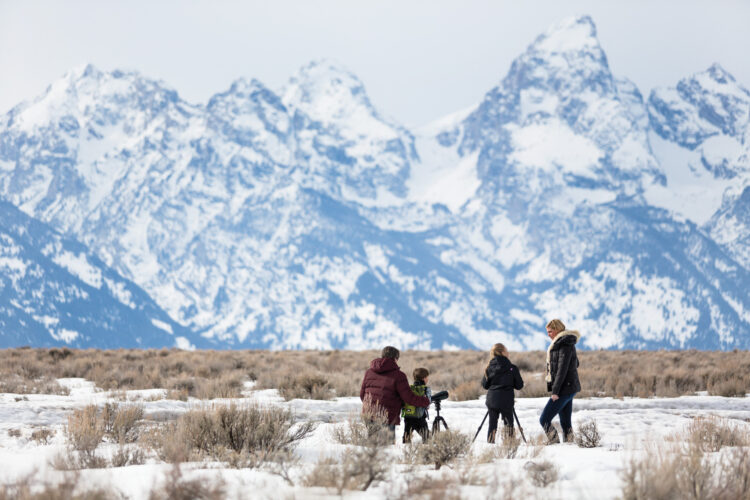 Family exploring snowy wilderness with scenic mountain views at Four Seasons Resort and Residences Jackson Hole during a luxury family holiday.
