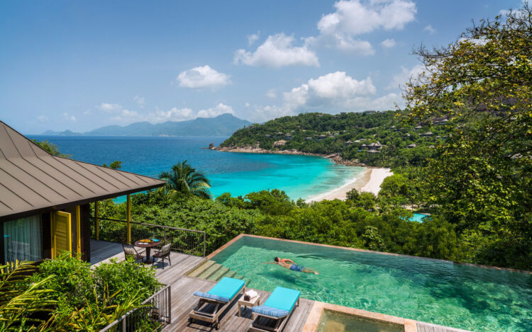 Private villa with infinity pool overlooking the turquoise waters at Four Seasons Resort Seychelles, ideal for luxury safaris and beach escapes