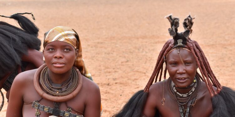 Himba women in traditional attire during a cultural experience on a luxury safari in Namibia