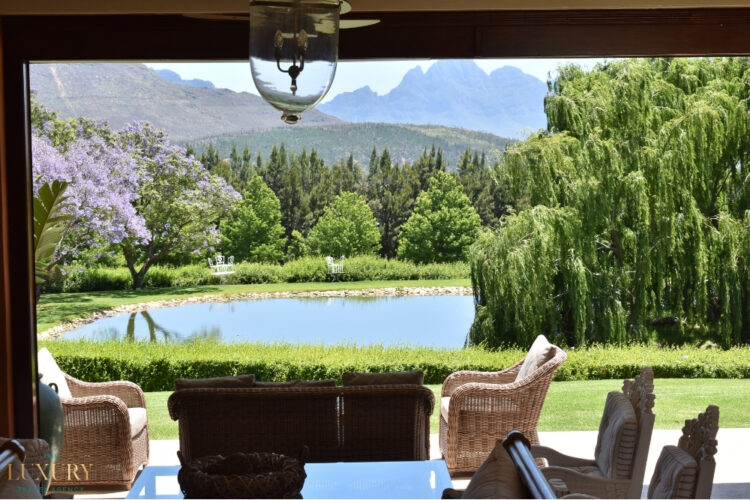 South Africa winelands luxury estate view with mountains and garden lake
