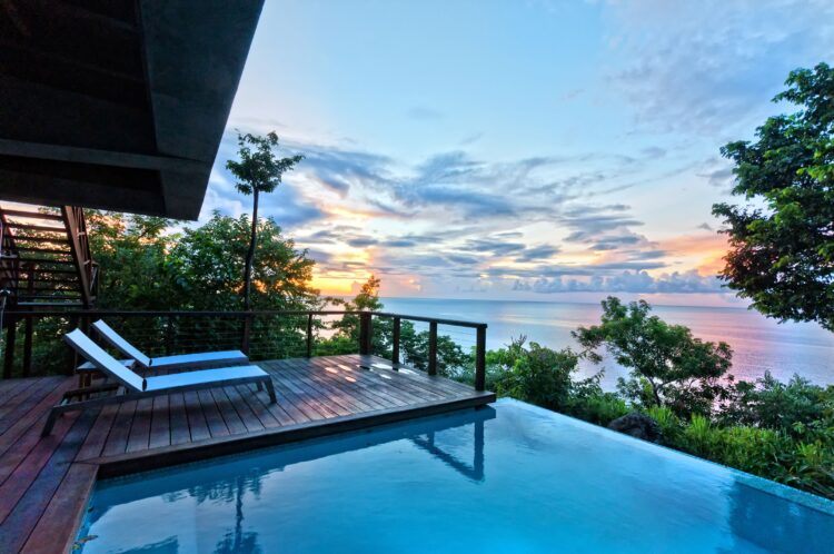 Secret Bay Dominica private villa with cliffside pool at sunset
