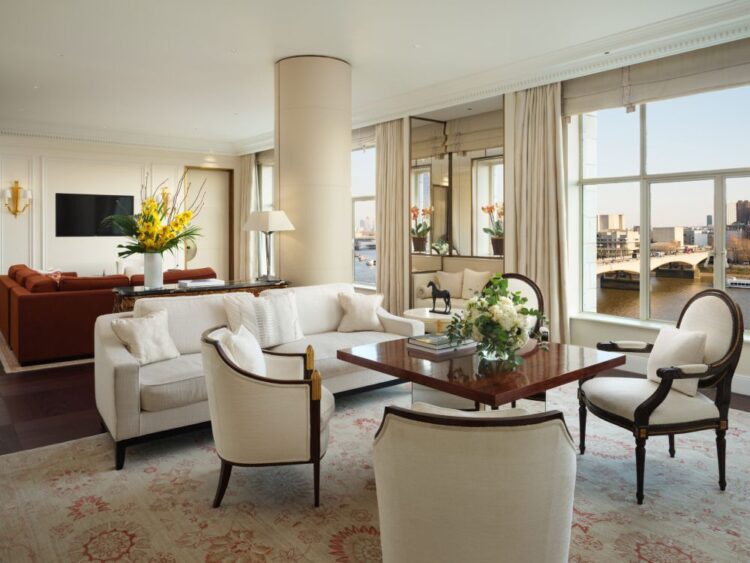 Spacious suite at The Savoy, one of the best luxury hotels in London, with elegant seating area and views over the Thames