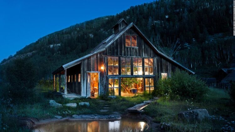 Dunton Hot Springs Colorado restored ghost town cabin at dusk with natural hot spring pool
