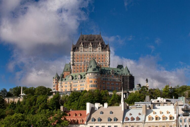 best places to travel in August — Quebec City Château Frontenac summer blue sky old town rooftops Canada