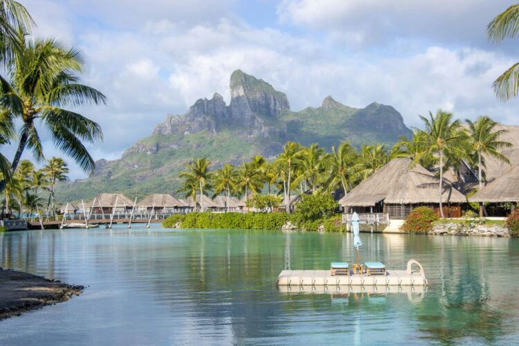 Bora Bora French Polynesia August travel — overwater bungalows palm trees calm lagoon Mount Otemanu luxury resort