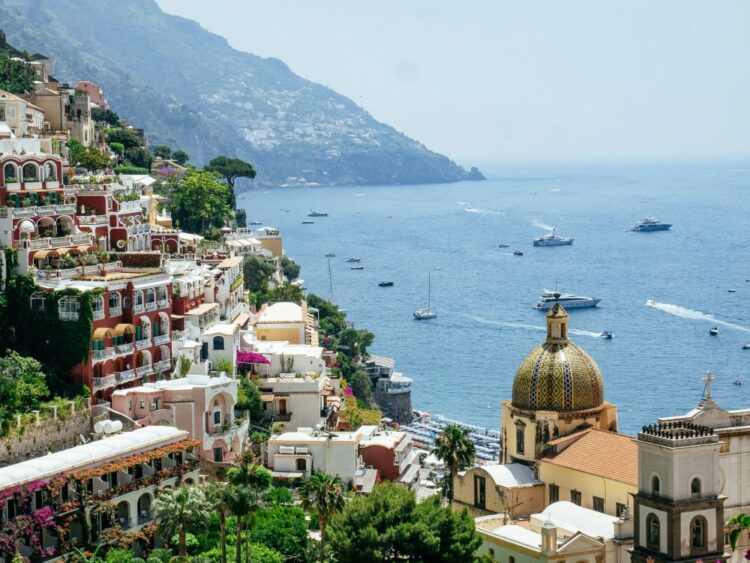 Positano on the Amalfi Coast with colorful hillside buildings and Mediterranean coastline, representing luxury yacht destinations