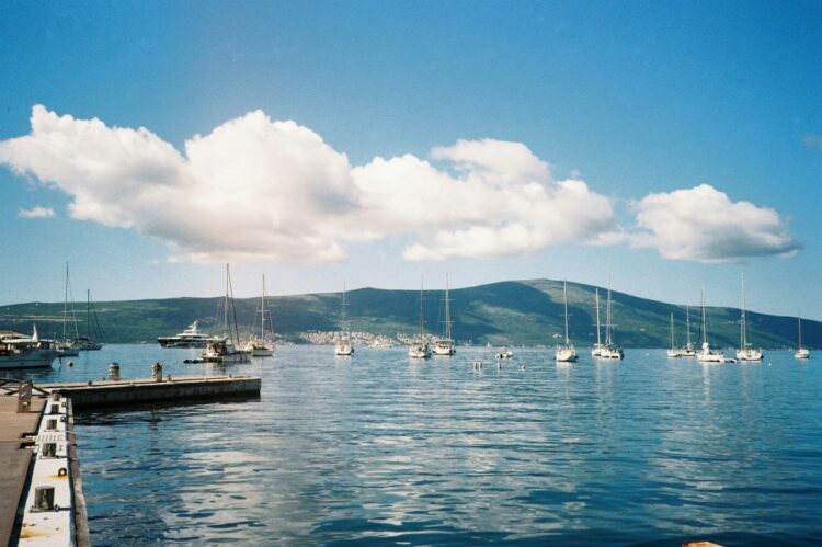 Montenegro Tivat Bay August travel — sailboats anchored marina Porto Montenegro green mountains Adriatic