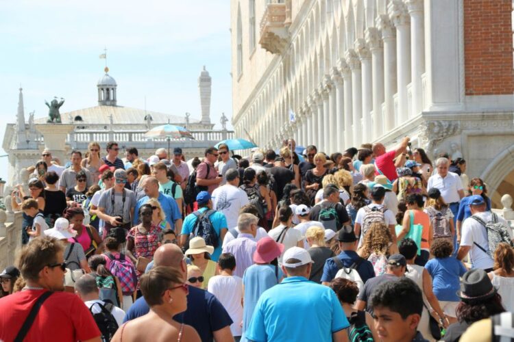 Crowded Venice street during peak summer travel in July
