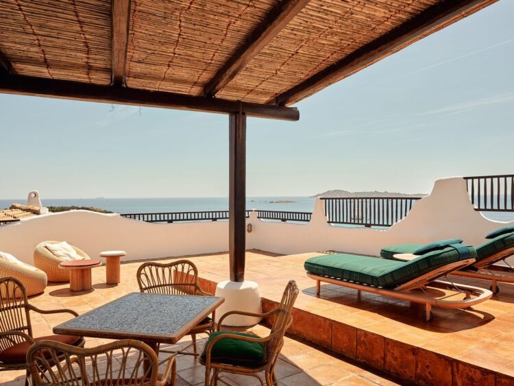 A suite terrace at Romazzino with sea view, thatched pergola, and green loungers, Costa Smeralda, Sardinia