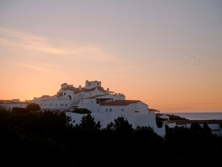 Belmond Romazzino at sunset — whitewashed architecture silhouette on the Costa Smeralda