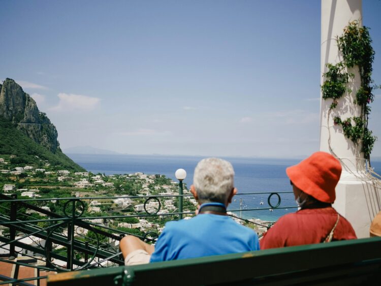Older couple enjoying a luxury milestone birthday trip overlooking the Mediterranean