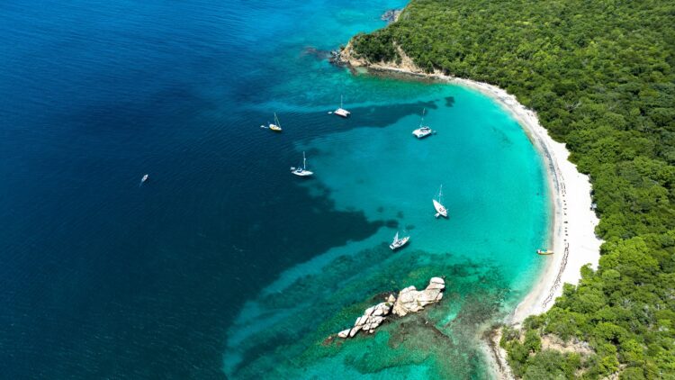 Sailboats anchored off the coast of Grenada during the best time to visit the Caribbean for sailing
